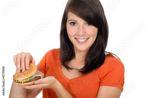 Photo: girl looking at a hamburger girl looking at a hamburger