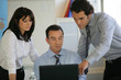 Three colleagues at laptop