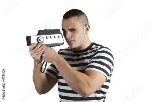 Photo: young man recording with old movie camera domestic young man recording with old movie camera domestic
