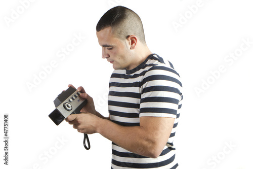 Photo: young man recording with old movie camera domestic young man recording with old movie camera domestic