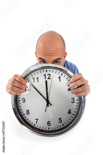 Photo: Covering his face with clock Covering his face with clock