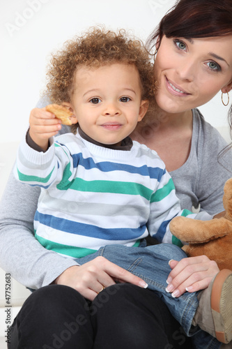 Photo: Boy eating cookies. Boy eating cookies.