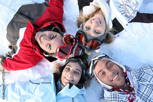 Photo: Friends lying in the snow Friends lying in the snow
