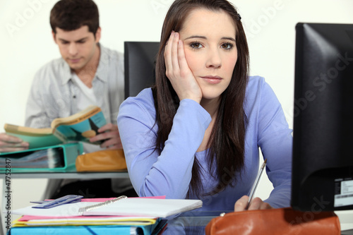 Photo: A cute brunette fed up of studying. A cute brunette fed up of studying.