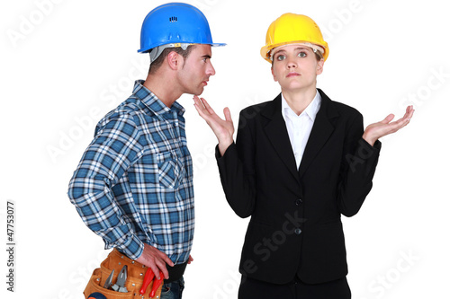 Photo: Angry foreman with helpless woman entrepreneur Angry foreman with helpless woman entrepreneur