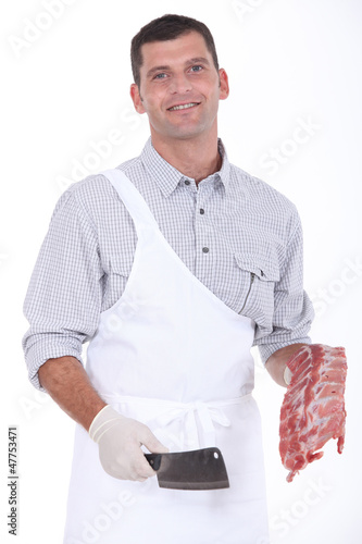 Photo: a butcher taking a chopper and pork ribs a butcher taking a chopper and pork ribs