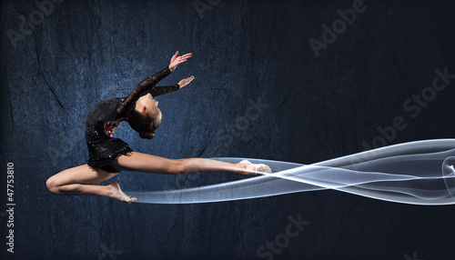 Photo: Young woman in gymnast suit posing Young woman in gymnast suit posing