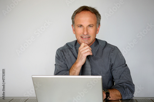 Photo: Businessman using a laptop computer Businessman using a laptop computer