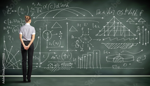 Photo: Business person against the blackboard Business person against the blackboard