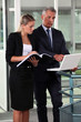 Boss and assistant working in a corridor