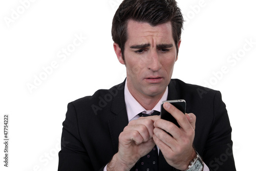 Photo: An anxious man texting. An anxious man texting.