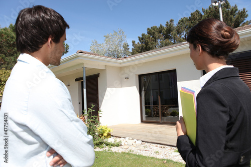 Photo: Estate agent about to show customer around property Estate agent about to show customer around property