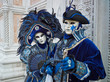 Person in Venetian costume attends Carnival of Venice.