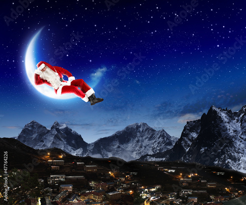 Photo: photo of santa claus sitting on the moon photo of santa claus sitting on the moon