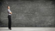 Business person against the blackboard