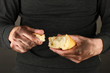 homeless man holding a white bread, close-up