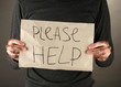 homeless man asks for help, on black background close-up