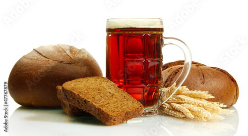Photo: tankard of kvass and rye breads with ears, isolated on white tankard of kvass and rye breads with ears, isolated on white