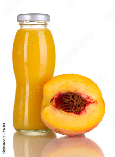Photo: Delicious peach juice in glass bottle and peach next to it Delicious peach juice in glass bottle and peach next to it