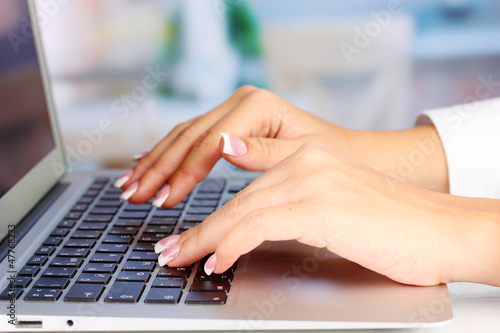 Photo: Hands typing on laptop keyboard close up Hands typing on laptop keyboard close up