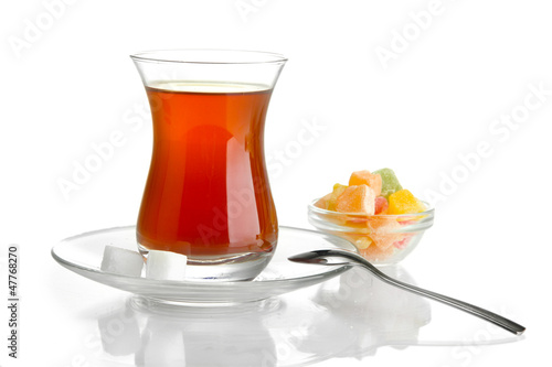 Photo: glass of Turkish tea and rahat Delight, isolated on white glass of Turkish tea and rahat Delight, isolated on white