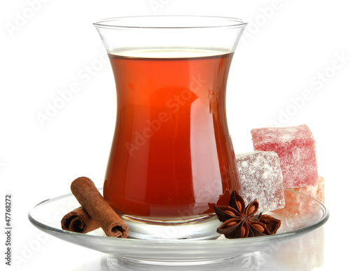 Photo: glass of Turkish tea and rahat Delight, isolated on white glass of Turkish tea and rahat Delight, isolated on white