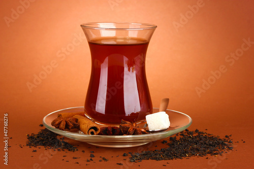 Photo: glass of Turkish tea, on brown background glass of Turkish tea, on brown background