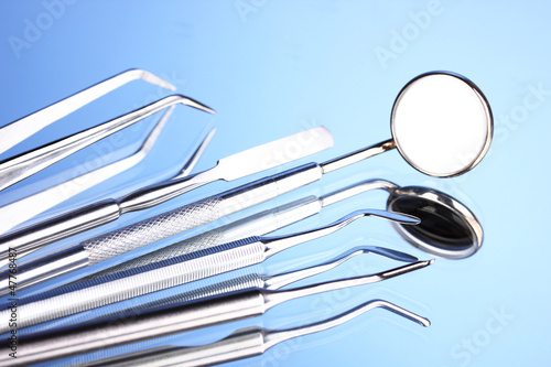 Photo: Set of dental tools for teeth care isolated on blue background Set of dental tools for teeth care isolated on blue background