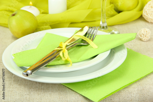 Photo: beautiful holiday table setting with apples, close up beautiful holiday table setting with apples, close up
