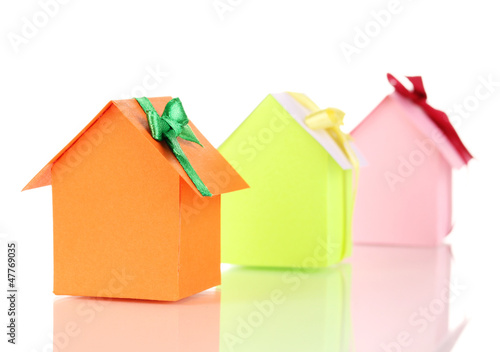 Photo: Small houses with ribbons isolated on white Small houses with ribbons isolated on white