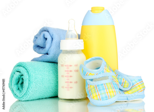 Photo: Bottle of milk, pacifier, shampoo and towel isolated on white Bottle of milk, pacifier, shampoo and towel isolated on white
