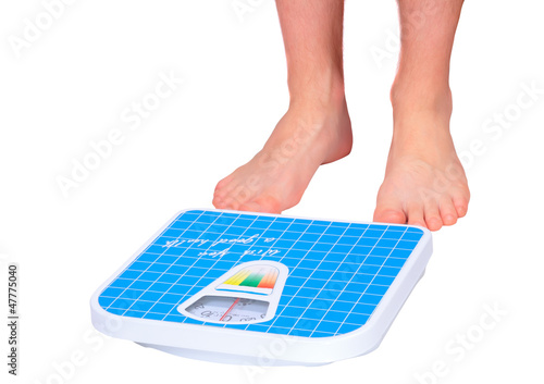 Photo: Man's legs ,which weighed on floor scale. Isolated Man's legs ,which weighed on floor scale. Isolated