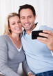 Couple photographing themselves on a mobile