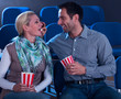 Loving couple sharing their popcorn
