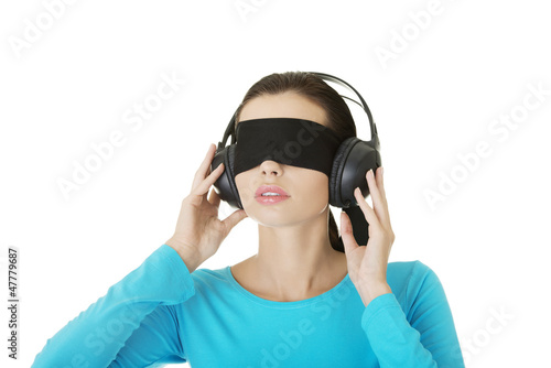 Photo: Blindfold attractive woman with headphones Blindfold attractive woman with headphones