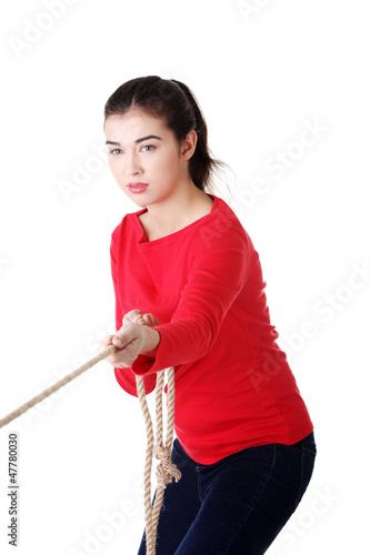 Photo: Adultl woman pulling a rope Adultl woman pulling a rope