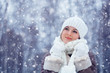 Photo: beautiful woman walking outdoors under snowfall beautiful woman walking outdoors under snowfall