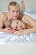 Young loving couple lying on bed