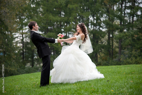 Photo: Newly married couple dancing in field Newly married couple dancing in field