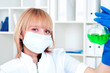 Foto: Woman chemist with the flask in a laboratory Woman chemist with the flask in a laboratory