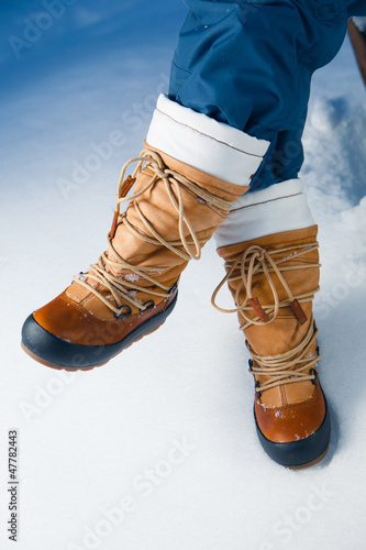 Photo: winter shoes in snow, close-up winter shoes in snow, close-up