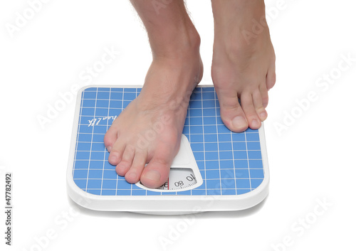 Photo: Man's legs ,which weighed on floor scale. Isolated Man's legs ,which weighed on floor scale. Isolated