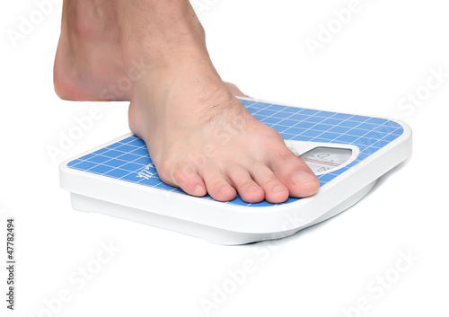 Photo: Man's legs ,which weighed on floor scale. Isolated Man's legs ,which weighed on floor scale. Isolated