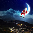 photo of santa claus sitting on the moon