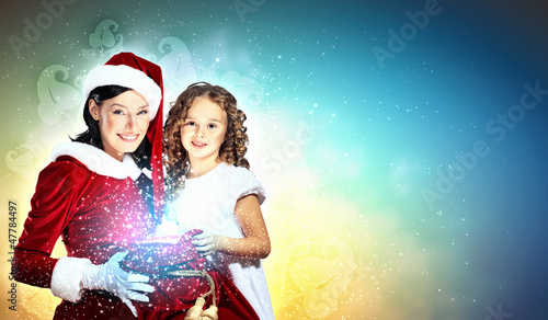 Photo: Little girl with christmas gifts and santa Little girl with christmas gifts and santa