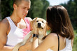 Foto: Young Couple Walking Dog Young Couple Walking Dog