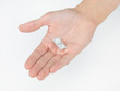 Photo: hand holding a tiny dollar bill hand holding a tiny dollar bill