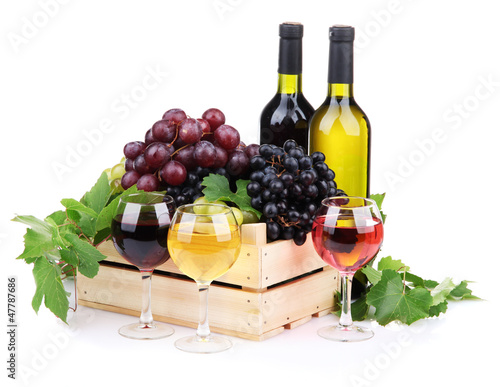 Photo: bottles and glasses of wine and assortment of grapes in wooden bottles and glasses of wine and assortment of grapes in wooden