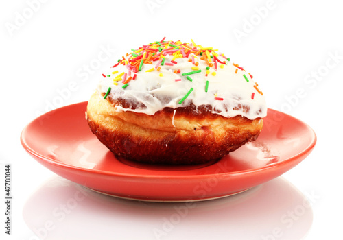 Photo: Tasty donut on color plate isolated on white Tasty donut on color plate isolated on white