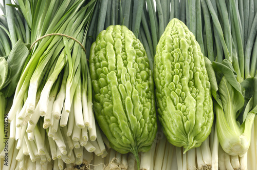 Photo: Close up fresh young onion and bitter melon Close up fresh young onion and bitter melon